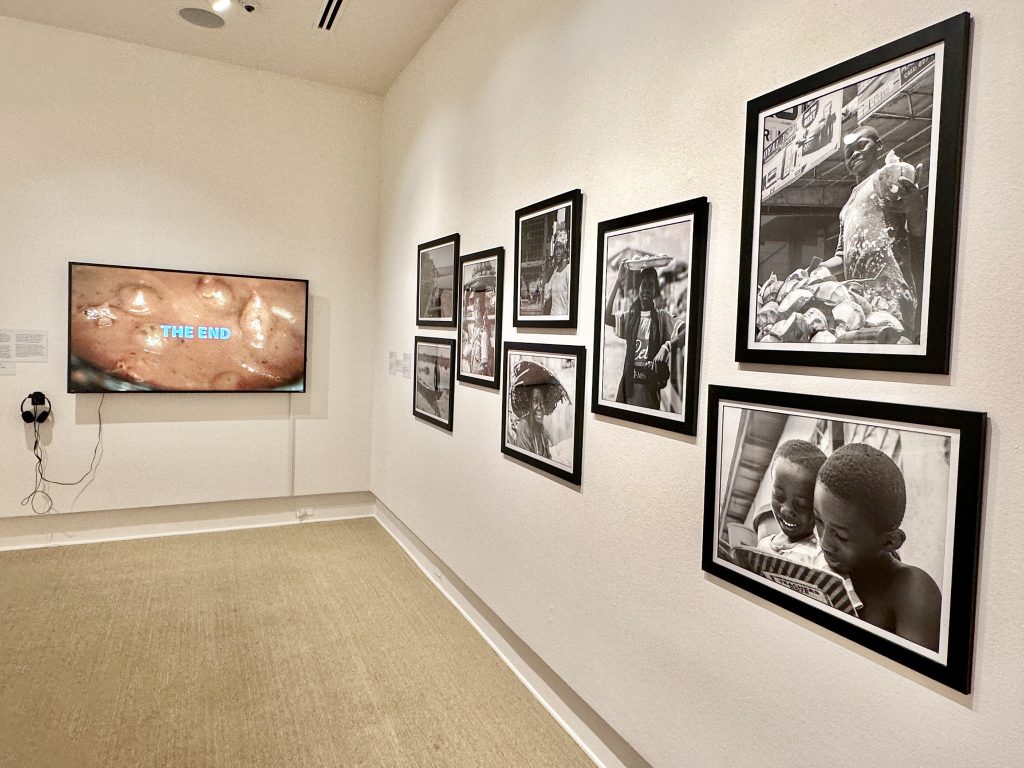 Rollins msueum of aRt Gallery with Samuel Aye-Gboyin black and white photos tv playing video on the wall