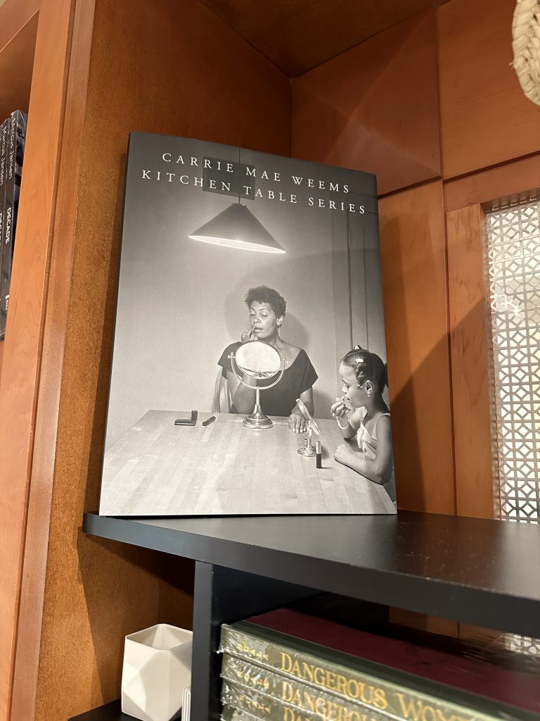 Carrie Mae Weems' Kitchen table series book on a bookshelf at The Rollins Museum of Art.